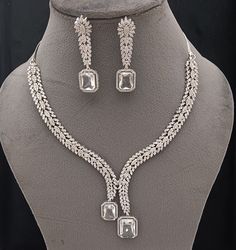 Faux CZ Diamonds White Necklace Earrings Set, Bridal Dangler Earrings, Bridal Choker, Party Wear Silver Necklace Earrings, Statement Piece ITEM DESCRIPTION Metal        = Silver Plated Occasion  = Wedding, Party Wear, Bridal Color        = White and Silver Size          = Necklace Length = 7 Inches Long, Earring Size = 2.5 Inches Long,  Free Shipping 100% Satisfaction Guarantee: 1 Year Warranty, Long Lasting Plating, High-Quality Stones Occasion: Perfect choice for any Indian occasion.  Care: It Bridal Choker, Dangler Earrings, White Necklace, Earrings Statement, Choker Necklaces, Cz Diamond, Necklace Earring Set, Necklace Earrings, Earrings Set