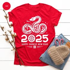 Customers who bought this t-shirt also bought our Custom Text T-Shirt. (https://www.etsy.com/listing/1765745872/custom-text-t-shirt-custom-text-4xl-5xl?) Christmas Family T-shirts Welcome! In our T-shirt store, you'll find a wide range of high-quality, comfortable, and stylish T-shirts for men, women, and kids. We offer various options, from classic solid colors to vibrant graphics and designs inspired by pop culture. Our T-shirts are crafted using premium materials to ensure they are gentle on Lunar New Year Party, Snake Shirt, Chinese Lunar New Year, Family T Shirts, Text T Shirt, Year Of The Snake, New Years Shirts, Happy Thanksgiving Day, New Year Party