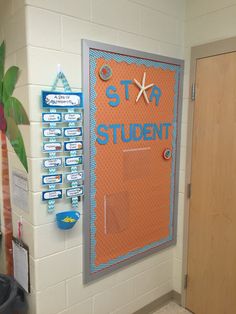 an orange bulletin board on the wall in a room with palm trees and other items