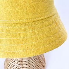 This yellow bucket hat is the perfect thing for babies toddlers and kids on sunny summer days! Washable linen and cotton fabirc makes it an easy go to for at the park, the beach, or even the backyard! This hat will protect delicate skin from the sun and will quickly become a favorite accessory! I made this sun hat from a bold yellow colored linen/cotton blend fabric. The strap closes with snaps under the chin keeps them from pulling it off. Brim measures approx. 2.25 inches. SIZES AVAILABLE 0-3 mos. - fits 14" to 16" head circumference 3-6 mos. - fits 15" to 17" head circumference 6-12 mos. - fits 16" to 18" head circumference 12-24 mos. - fits 17.5" to 19.5" head circumference Small (3 to 5 yrs) - fits 19" to 21" head circumference OVERVIEW + Sewn by me + Yellow Linen and Cotton blend Fab Solid Color Cotton Sun Hat For Summer, Cotton Summer Sun Hat, Solid Cotton Summer Sun Hat, Solid Color Cotton Summer Sun Hat, Summer Cotton Sun Hat For Everyday, Cotton Bucket Sun Hat For Summer, Casual Yellow Bucket Hat For Beach Season, Yellow Sun Hats For Spring, Yellow Cotton Summer Bucket Hat