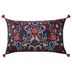 an embroidered pillow with red, blue and white flowers on it's side is shown