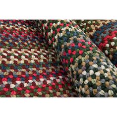 multicolored rugs are stacked on top of each other in the same pattern