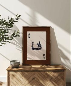 a wooden cabinet sitting next to a potted plant