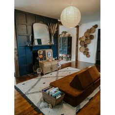 a living room filled with furniture and a large mirror