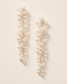 Fabulous & fun for any outfit, you'll love our Cascading Pearl & Crystal Earrings. Made with ivory pearls and crystal beads that dangle beautifully to frame the face. Details: Made with light ivory pearls and crystals along a silver chain. Specifications: 3" in length x 0.5" wide. Extremely lightweight. Easily worn all day and evening. Tarnish Resistant: Earring metals are tarnish resistant for long lasting shine. Hypoallergenic: Earrings are hypoallergenic, lead-free & nickel-free. Style #4479 Pearl Charm Chandelier Earrings For Party, Pearl Chandelier Earrings For Party, Pearl Bridal Earrings For Party, Pearl Charm Dangle Chandelier Earrings For Party, White Pearl Charm Chandelier Earrings For Party, Pearl White Chandelier Earrings With Pearl Drop For Parties, Party Pearl Earrings With Beaded Detail, Pearl White Dangle Chandelier Earrings For Party, Beaded Pearl Earrings For Party