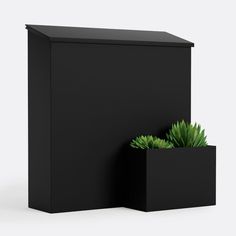 a black box with a planter on the side and another container behind it that has a succulent in it