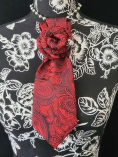 This  Red Paisley Necktie Necklace is made with a woven silk tie, and features a Silver Rhinestone Bumble Bee Brooch strung on your choice of an adjustable Rosary Chain Ribbon Tie Pearl Necklace or an adjustable Elastic Band. The soft, comfortable fabric sits perfectly on any size chest, while the adjustable necklace feature allows you to customize the fit to your liking. Measuring at a versatile length, this necktie necklace is designed to be a one-size-fits-all. View all Women Tie's: https://www.etsy.com/shop/FearlessAccessorizer?ref=seller-platform-mcnav§ion_id=49097355 The single strand of pearls is an easy and fashionable way to wear this tie necklace. Looks really cute on a t-shirt or a blouse. All jewelry is individually handmade solely by me the designer and owner of Fearless & Fai Necktie Necklace, Necktie Crafts, Women Necktie, Tie Necklace, Women Ties, Red Paisley, Jewelry Brooch, Bee Brooch, Handmade Beaded Necklaces