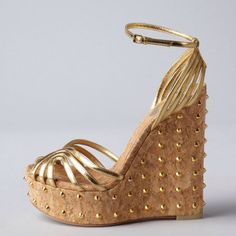 Elevate your style with these stunning Gold Metallic Wedge Sandals. Featuring a peep toe design, strappy details, and studded platform heels, these sandals are perfect for adding glamour to any outfit. Color: Gold Material: Metallic finish Heel Type: Wedge heel Heel Height: 5.5" / 140 mm approx Product measurements were taken using size 8. Please note that measurements may vary by size Toe: Peep toe Adjustable ankle strap design Gold stud embellishment Handcrafted US sizing. Fits true to size. High Heel Sandals With Spikes For Spring, Summer Spiked Open Heel Heels, Chic Open Toe Sandals With Spikes, Spring High Heels With Gold Studs, Party Open Toe Sandals With Gold Studs, Party Sandals With Gold Studs And Open Toe, Spiked Open Toe Wedge Sandals, Summer Wedge Sandals With Spikes, Summer Party Heels With Gold Studs