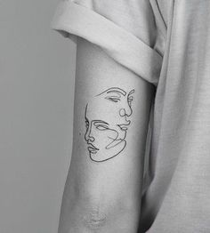 a woman's arm with a line drawing of a man's face on it