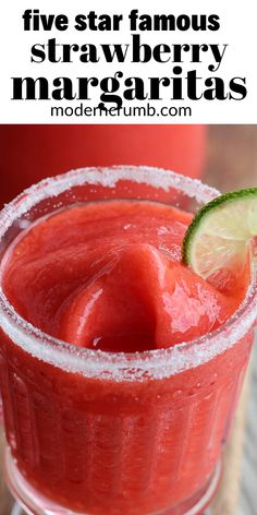 a close up of a drink in a glass with ice and watermelon on the rim