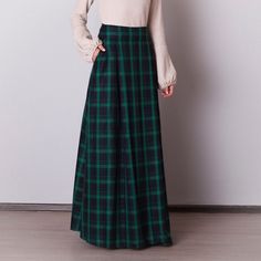 Black and green plaid skirt: - Side seam pockets - Hidden zipper on the back - Lined belted part - Classic tartan pattern - Fabric is 40% wool, 58% polyviscose, 2% of elastane Model is 6'2'', she wears US 8 size US 0  Bust 82 cm (32.5 inches) Waist 64 cm (25 inches) Hips 89 cm (35 inches) US 2  Bust 85 cm (33.5 inches) Waist 66 cm (26 inches) Hips 92 cm (36 inches) US 4  Bust 88 cm (34.5 inches) Waist 68 cm (27 inches) Hips 94 cm (37 inches)  US 6  Bust 90 cm (35.5 inches) Waist 71 cm (28 inches) Hips 96 cm (38 inches)  US 8  Bust 93 cm (36.5 inches) Waist 74 cm (29 inches) Hips 99 cm (39 inches) US 10  Bust 95 cm (37.5 inches) Waist 76 cm (30 inches) Hips 102 cm (40 inches) US 12  Bust 99 cm (39 inches) Waist 80 cm (31.5 inches) Hips 105 cm (41.5 inches) US 14  Bust 103 cm (40.5 inches) W Long Green Skirt For Fall, Green Lined Skirt For Fall, Green Pleated Skirt For Fall, Green Long Skirt Bottoms For Fall, Green Lined Maxi Skirt For Fall, Green Long Skirt For Fall, Green Pleated Maxi Skirt For Fall, Fitted Green Maxi Skirt With Pockets, Fall Green Lined Maxi Skirt