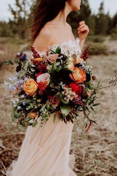 a woman holding a bouquet of flowers in her hands