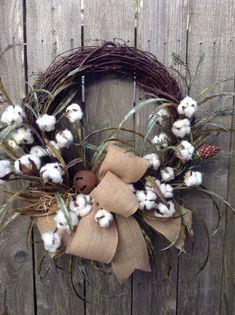 a wreath with cotton and a button on it is displayed in an instagramtion