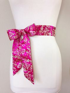 "Hot Pink Sash in Asian Brocade Pink Floral Sash in Gold Satin Brocade Hot Pink Obi Belt, Kimono Sash Chinese Brocade Sash Satin Swank Elevate your style instantly with this Satin Swank® Asian brocade sash in hot pink and floral gold. Sometimes called Chinese brocade, satin brocade, or silk brocade, this is a weighty fabric intricately woven into an elaborate pattern. At two inches wide and 75 inches long, this brocade sash will give most waist sizes the option of tying it in a bow with short ta Elegant Fitted Pink Sashes, Fitted Sashes With Satin Bow, Formal Sashes With Matching Belt, Chinese Brocade, Belt Kimono, Pink Sash, Open Sweater, Obi Belt, Gold Satin