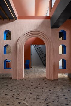 the interior of a building with blue and pink arches