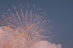 a large fireworks display in the sky with clouds