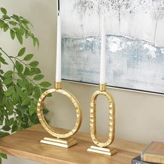 two candles sitting on top of a wooden table