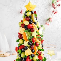 a christmas tree made out of fruits and berries