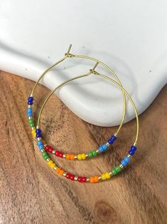 Pride Rainbow Hope Earrings 🏳️🌈 sterling silver or 18k gold plated hoops Available in 20mm, 30mm, or 40mm diameter! Multicolor Tiny Beads 14k Gold Filled Jewelry, 14k Gold Filled Multicolor Tiny Beads Jewelry, Nickel-free Multicolor Everyday Jewelry, Everyday Multicolor Nickel-free Jewelry, Adjustable Cadmium-free Hoop Earrings As Gift, Everyday Rainbow Round Jewelry, Rainbow Round Beads Jewelry With Ear Wire, Rainbow Nickel-free Dangle Hoop Earrings, Nickel-free Rainbow Dangle Hoop Earrings