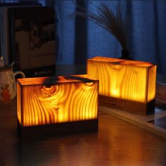 two wooden boxes sitting on top of a table