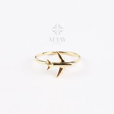 a gold ring with an airplane on it