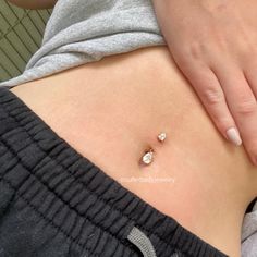 a close up of a person's stomach with two small diamonds on the side