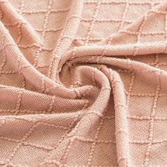 the texture of a pink blanket is shown