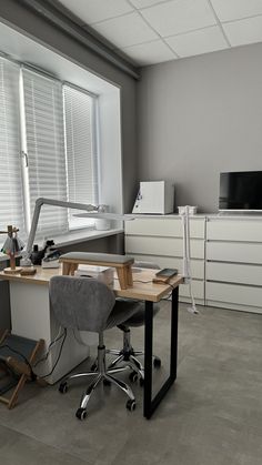 an office with two desks and chairs in it