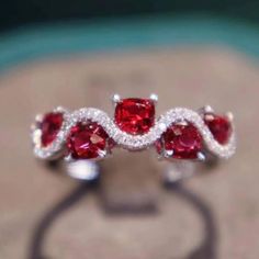 Exquisitely designed ring band features beautiful cushion shape vivid red spinels accented with petite round diamonds. The combination of these gemstones and gorgeous curving pattern of spinel and diamond makes this already unique ring a remarkable delicate piece. This Ring has gorgeous shine, superior quality and craftsmanship Details: 18K Solid white gold 1.30 ct Vivid Red Spinel 0.16 ct Genuine Diamonds Fabrication process usually takes 5-14 days, if you need it earlier, please let us know. Red Cushion Cut Ring With Accent Stones, Red Cushion Cut Gemstone Ring, Luxury Radiant Cut Red Ring, Cushion Cut Ruby Gemstone Rings, Ruby Rings With Accent Stones In Cushion Cut, Ruby Rings With Cushion Cut And Accent Stones, Red Spinel Ring, Daisy Engagement Ring, Butterfly Diamond Ring