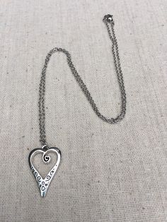 "This is such a unique and whimsical heart pendant necklace. It has incredible detail and another little heart showcased inside the main heart. This would make a very sweet and meaningful gifts for a loved one on any occasion. The heart measures 1\" long by 5/8\" wide and is made from allergy free plated silver. It hangs from a simple 18\" stainless steel necklace chain. I have matching earrings in my shop, if you would like the whole set. Here is the link https://etsy.me/30EwF2x Thanks for stop Whimsical Silver Necklaces For Mother's Day, Whimsical Silver Necklace For Mother's Day, Silver Bohemian Necklace For Valentine's Day, Bohemian Silver Necklace For Valentine's Day, Whimsical Metal Jewelry For Gifts, Adjustable Metal Heart Necklace, Adjustable Metal Heart Necklace With Charm, Adjustable Metal Heart Necklace For Valentine's Day, Adjustable Metal Heart Pendant Necklace