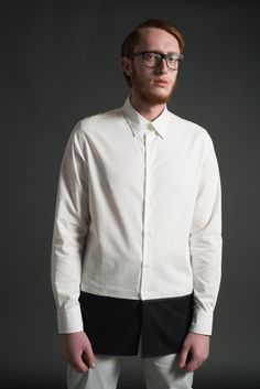 An elongated tunic shirt with black and white color block design by ARIEL BASSAN.ARIEL BASSAN is a sophisticated and contemporary menswear brand, that offers a unique and fresh high quality garments with a distinct signature of modern minimalism.This shirt is made out of a 100% Cotton, Crisp Woven Fabric. It has a contrasted hem panel with a ribbed tape detail.The extremely modern longline silhouette, with a longer back hem, will give you a slim and elongated sophisticated look.Model's height is Modern Semi-formal Spring Dress Shirt, Modern Slim Fit Top For Semi-formal Occasions, Modern White Dress Shirt For Semi-formal Occasions, Modern Slim Fit White Tops, Modern Slim Fit White Top, Modern Semi-formal Shirt With Relaxed Fit, Modern Relaxed Fit Shirt For Semi-formal Occasions, Modern White Slim Fit Tops, Modern White Slim Fit Top