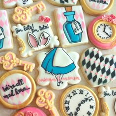 decorated cookies with different designs and words on them, including an image of a clock