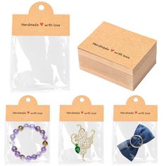 four different bracelets in wooden boxes with tags on the front and back, each featuring an individual's favorite charm