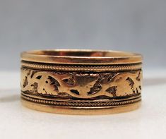 "Offering a beautiful 14k  Rose Gold Victorian eternity band.   It has an engraved pattern with vines etched going all the way around the band.   It measures 7.55mm wide so it makes a nice presentation.  I love the rose gold with engraving adding dimension to the band. The band is marked \"14\".   It is a size 6.25 however due to the band being wide, it fits more like a 6.     The band weighs 3.1 grams.   I love these old wide Victorian engraved bands.   This would work for either a man or woman.   I have been selling jewelry for two decades. I am not a gemologist and not qualified to grade diamonds. I do occasionally give an estimate to the best of my ability to give you some idea of the quality of the diamond to aid in your decision, as well as the pictures. My items are vintage items an Vintage Engraved Wedding Rings, Antique Wedding Bands, Diamond Sapphire Engagement Ring, Sapphire Diamond Engagement, Engraved Wedding Rings, Old Rings, Antique Roses, Diamond Rings Bands, Eternity Band