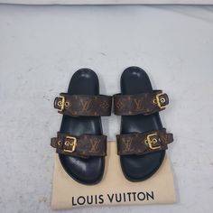 Louis Vuitton Brown Buckle Bom Dia Monogram Flat Slide Sandal Size Eu 36.5 Us 6.5 Womens Comes With Dustbag 100% Authentic *Price Is Firm* Color: Cacao Brown Classic Dark Brown Slip On Sandal With Allover Lv Monogram Print Patent Monogram Canvas Adjustable Strap Anatomic Insole Treaded Rubber Outsole Louis Vuitton-Engraved Buckle Monogram Pattern On The Tread Please Note Signs Of Wear On Bottom As Shown. Please Note Scratches/Scuffs Have Been Polished Over As Shown. Please Note Faded Text On Footbed As Shown Lv Slides, Monogram Pattern, Louis Vuitton Brown, Lv Monogram, Monogram Prints, Louis Vuitton Shoes, Monogram Canvas, Slide Sandals, Slip On Sandal