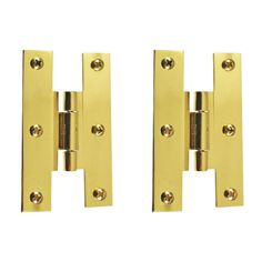 pair of brass plated door hinges on white background