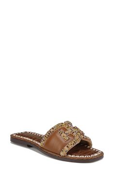 A beaded logo adds unmistakable signature style to this sleek slide sandal. Leather upper/synthetic lining and sole Imported Trendy Brown Flat Slides, Designer Brown Slides With Cushioned Footbed, Trendy Brown Slip-on Slides, Designer Brown Flat Slides, Brown Slides With Buckle Closure, Trendy Brown Leather Slides, Brown Woven Sole Slides, Designer Brown Slides For Spring, Trendy Brown Synthetic Slides