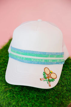 Get ready to serve some serious style with our Playing Doubles Ribbon Trucker Hat! This white trucker hat features a unique turquoise and blue striped ribbon and a playful tennis rackets patch on the bill. Perfect for any casual or sporty look. Game, set, match! White Trucker Hat, Game Set Match, Tennis Rackets, Striped Ribbon, The Bill, Sporty Look, Tennis Racket, Trucker Hat, Activities For Kids