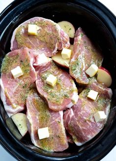 raw meat and potatoes in a slow cooker