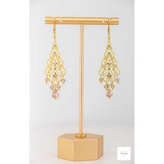 These unbelievably pretty and fashionable Amber glass filigree dangle earrings are a stunning addition to any jewelry collection. The shimmering, faceted amber glass beads are perfectly paired with the lovely gold-plated filigree and lever backs for a lightweight, secure fit and luxurious look. Beautiful, Amber and white colored faceted glass beads. Gold-plated filigree. Gold-plated wire and lever backs. 2.75 inches long. These earrings are perfect for a night out or a special event and make a m Elegant Long Drop Crystal Earrings With Dangling Beads, Elegant Teardrop Crystal Earrings With Dangling Beads, Gold Crystal Earrings With Dangling Beads For Wedding, Elegant Czech Glass Jewelry With Matching Earrings, Elegant Gold Dangle Beaded Earrings, Elegant Gold Beaded Dangle Earrings, Handmade Elegant Adjustable Chandelier Earrings, Handmade Adjustable Elegant Chandelier Earrings, Nickel-free Czech Glass Earrings For Wedding