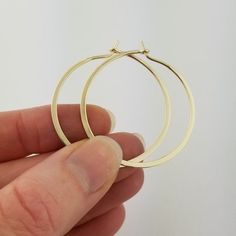 Gorgeous Solid 14k Hoops made from 16 gauge (1.3 mm) wire.  The wire is hammered to nearly flat for a beautiful bold look.  Due to the handmade nature of these hammered earrings, there may be very slight surface inconsistencies rather than a fully flat 'machined' style surface.1.5" Size pictured in photographs; 2" size shown in videoMETAL: Solid 14k Yellow GoldWIRE GAUGE/DIAMETER: 16 gauge (1.3 mm) wire - Currently the thickest wire I offerEAR WIRE THICKNESS: Due to the thickness of the wire, th Nickel-free 14k Gold Hoop Jewelry, Handmade 14k Gold Hoop Earrings, Handmade 14k Gold Hoop Jewelry, Hand Forged 14k Gold-filled Round Earrings, Handmade 14k Gold Hoop Earrings Gift, Hand Forged Hoop Earrings In 14k Gold Filled, Hand Forged Yellow Gold Hoop Earrings, Hand Forged 14k Gold Round Earrings, Handmade 14k Yellow Gold Hoop Earrings