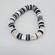 Seint Beauty Black & White Bracelet Handmade With Flat Clay Beads, Feel Like Rubber Letter Blocks Are White With Gold Letters. #Seint Black Bracelets With Letter Beads For Beach, Black Letter Beads Bracelet For Beach, White Stretch Bracelet With Black Beads Gift, Pandora Graduation Charm, Flat Clay Beads, Shiny Bracelets, Letter Blocks, Candy Bracelet, Flexible Bracelet