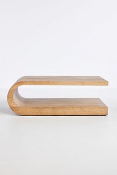 a wooden shelf sitting on top of a white floor