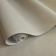 a roll of white fabric on top of a table