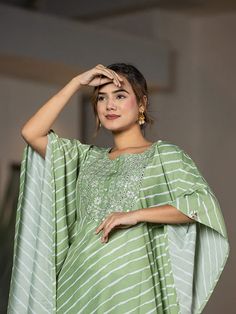 This 2-piece set includes green embroidery & leheriya print kaftan style kurta has round neck, short flared sleeves, flared hem, calf length teamed with solid trouser pants with elasticated waistband & slip on closure. 2 Piece Set Color-Green Kurta Fabric- Silk Blend Work - Thread Work Embroidery & Leheriya Print Detailing Neck - Round Neck Sleeves - Short Flared Sleeves Length-Calf Length Pocket - Single Pocket Bottom - Solid Trouser Pants Size & Fit - Elasticated Waistband Bottom - Slip-on Closure Washing Care-Hand Wash The model height 5'8 is wearing a size small Thread Work Embroidery, Green Embroidery, Kaftan Style, Thread Work, Fabric Silk, Womens Size Chart, Green Silk, Trouser Pants, Flared Sleeves