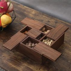 a wooden box filled with nuts on top of a table