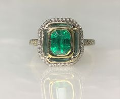 Colombian Emerald Ring, Emerald Engagement Ring, Emerald Diamond Ring, Emerald Cut Ring, Emerald Ring Gold, Emerald Ring for Women, Bezel Set Ring A luxurious and enchanting Colombian Emerald Ring featuring a glowing emerald cut center stone weighing 1.54 carats accented by 0.30 carats of sparkling white diamonds while secured by a bezel setting. Set in two toned solid yellow and white 18k gold. Ring size: US 7 3/4 Ring weight: 5.35 Grams Stone dimensions: 6.3 X 4.8mm *Complimentary resizing is Luxury Octagon Halo Setting Ring, Emerald Cut Gemstone Halo Ring In White Gold, Octagon White Gold Emerald Ring With Halo Setting, Luxury Octagon Ring With Bezel Setting, White Gold Octagon Emerald Ring With Halo Setting, White Gold Octagon Ring With Accent Stones, Fine Jewelry Diamond Ring With Octagon Halo Setting, Octagon Yellow Gold Jewelry With Halo Setting, Gia Certified Yellow Gold Emerald Cut Halo Ring