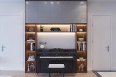 a living room with a piano and bookshelves