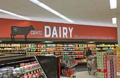 an empty grocery store with dairy products on display