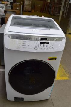 a white washing machine sitting on top of a floor